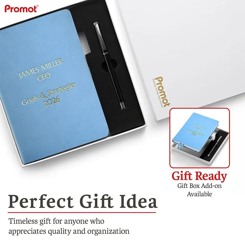 Blue notebook with custom gold engraving in a gift box beside a pen, a personalized leather journal ready for gifting.