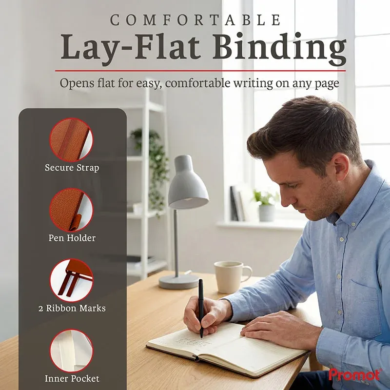 Man writing in an open brown personalized leather journal on a desk, highlighting its lay-flat design and ribbon bookmarks.