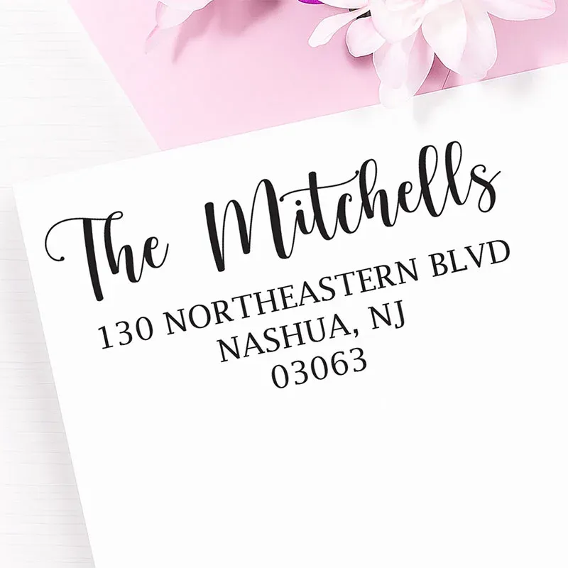 Personalized address stamp impression with The Mitchells return address on a white envelope