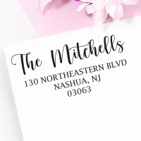 Large personalized address stamp impression with The Mitchells return address on a white envelope