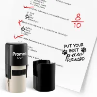 Hand holding a black and beige “Promot 170R” Teacher Ink Stamp over a worksheet with a red “Excellent” paw print stamp. Text on image says “Character Teacher’s Stamp,” “Multiple Designs,” “Compact & Portable,” “Self-Inking Technology,” and “Impression Siz