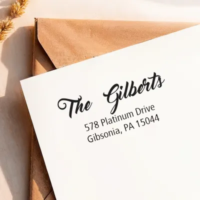 Custom Address Stamp imprint featuring an elegant family name and mailing address on white cardstock